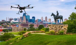 A drone hovers near the Scout statue overlooking downtown Kansas City, symbolizing the use of aerial LiDAR mapping in modern urban development.