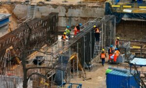 Structural engineers and construction workers building strong foundations for Grand Rapids riverfront redevelopment project