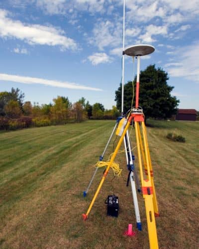 Survey equipment open fiel - ALTA SURVEY Missouri Surveying equipment set up in an open field, showing how a due diligence survey helps confirm accurate land boundaries for buyers and developers