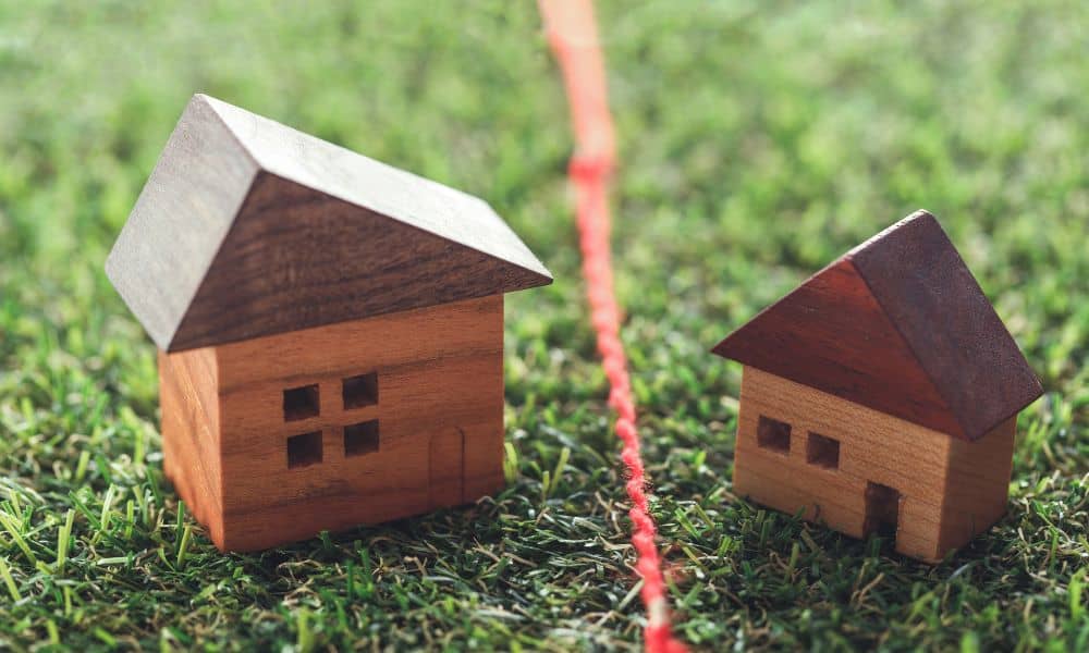 Residential properties divided by a visible line, illustrating why a boundary survey becomes important after property reassessments