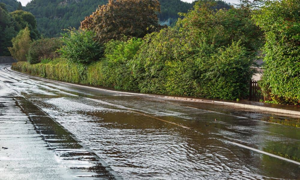 Surface water flowing along a sloped city street as documented in a topographic survey for drainage analysis