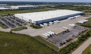 Aerial view of a Kansas City industrial warehouse with loading docks, truck courts, trailer parking, and outdoor storage areas