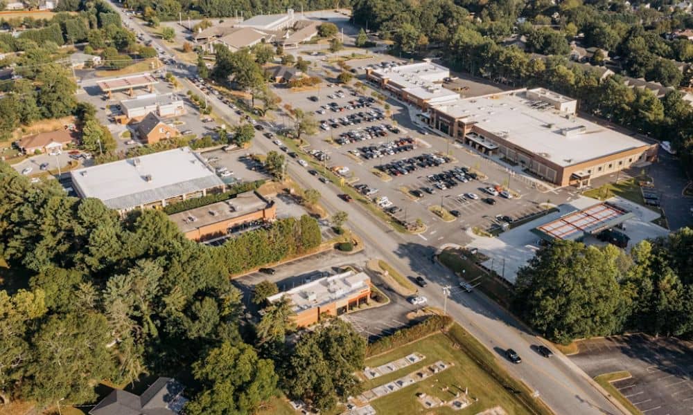 Aerial view of a commercial property showing how an ALTA title survey can document buildings, parking areas, and roadside land