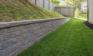 Property line retaining wall - ALTA SURVEY Missouri Retaining wall along a residential property line with a sloped yard and privacy fence